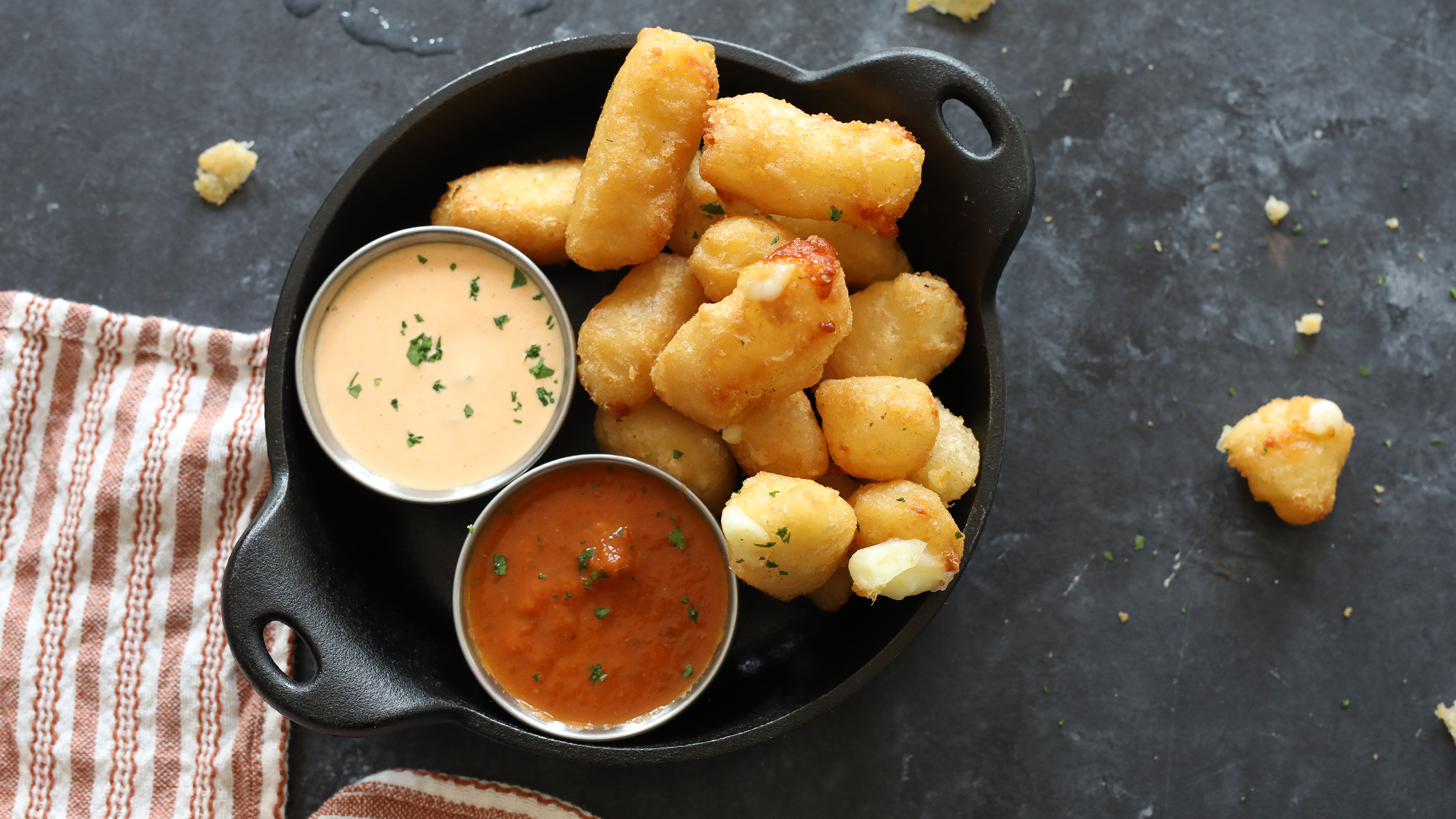 cheese curds on a dark table