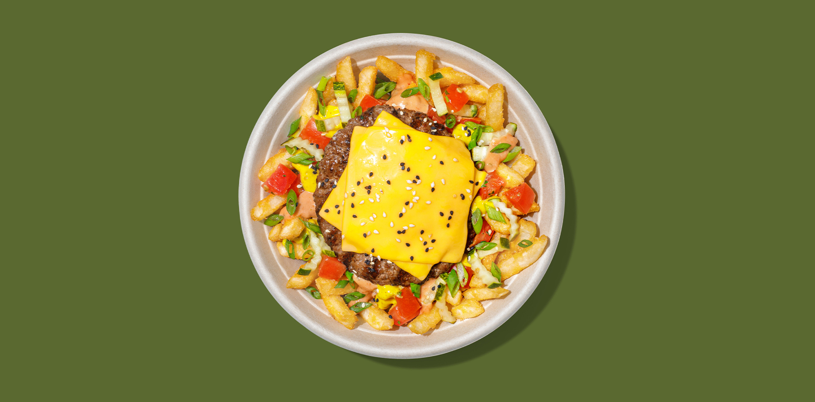  New Roadtrip Bowl called Cheeseburger FryBowl™ with Quarter-pound hamburger with double american cheese, bark + bite sauce-smothered fries, housemade liquid blanket® IPA mustard, pickles, tomatoes, green onions, sesame seeds alt tag