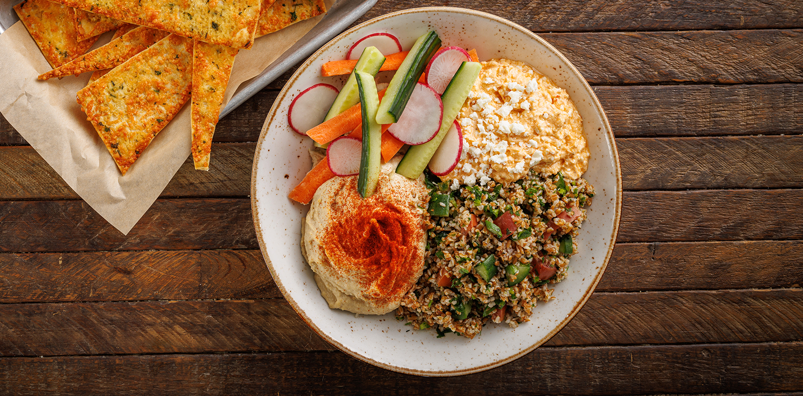 Hummus, spicy feta dip, tabbouleh grains, veggies + lavash garlic chips. Also available on the happy hour and late-night happy hour menus