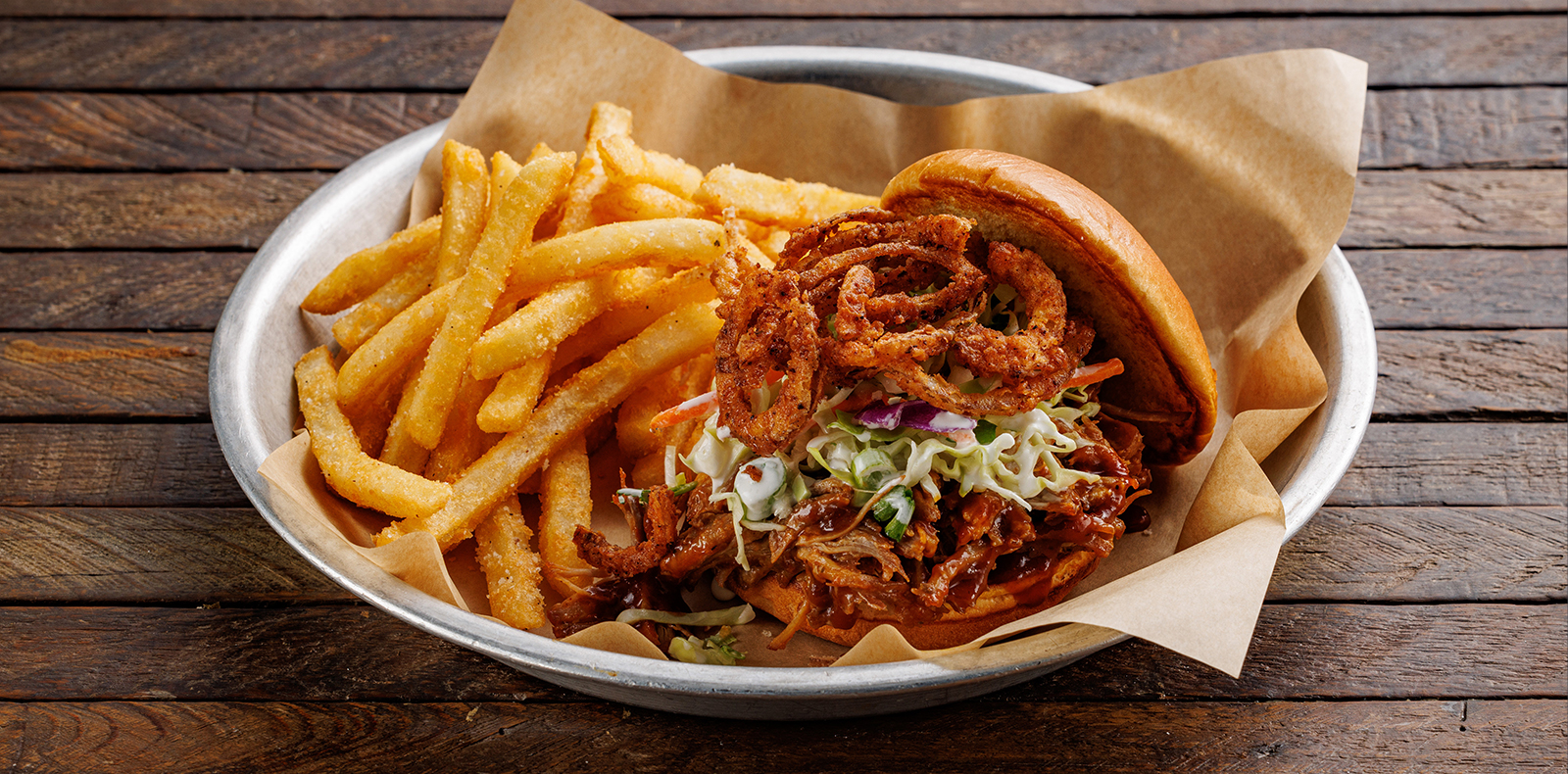 Pulled pork in a tangy Carolina-style BBQ sauce, coleslaw + crispy onion straws