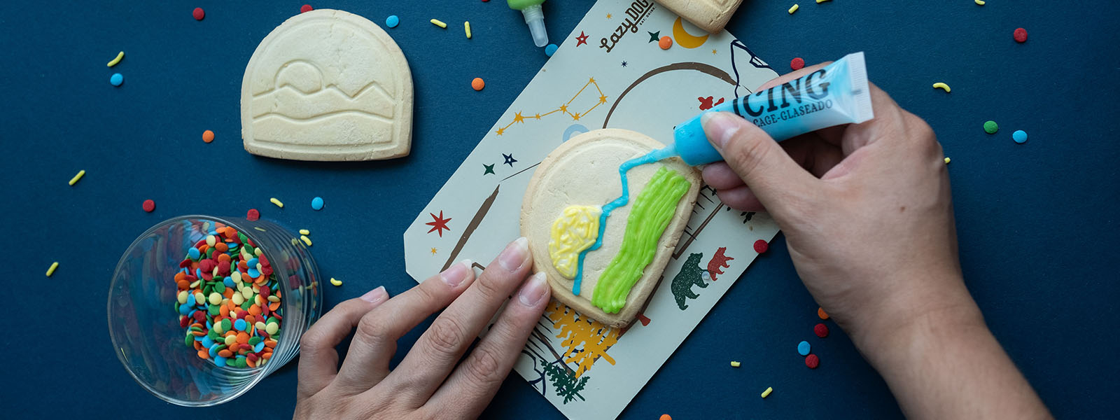 Colored Icing being used to decorate cookie